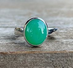 Gorgeous and smooth green Chrysoprase gemstone is set into sterling silver, and perched atop a sterling silver band. Fabricated from scratch and built to last. Made to order in your size.  Chrysoprase: 12mm x 10mm Band width: 3mm Will arrive gift-boxed. My jewelry is handcrafted one piece at a time by me in my home studio in Portland, Oregon. If I can help you with any questions about this piece or any of my other products, please feel free to contact me: hello @ paulla.com PIN IT on PINTEREST F Chrysoprase Ring, Ethiopian Opal Necklace, Middle Finger Ring, Sapphire Solitaire Ring, Green Gemstone Ring, Faceted Ring, Green Stone Rings, Bezel Ring, Solid Gold Earrings