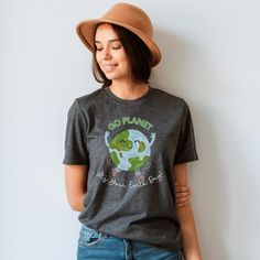 Go Planet, it's your Earth Day! This Teacher Tee is exclusively designed by Teacher Care Crate, so you won't find it anywhere else. Celebrate our Earth in style! This unisex, softstyle t-shirt is a perfect way to show off your teacher pride. It features a cute, dancing Earth design, making it both fun and unique. The shirt is made from very soft materials, this tee is 100% cotton for solid colors. Heather colors and sports grey include polyester. Gildan Softstyle Tee Solid colors are 100% ring-s Casual Graphic Print Shirt For Earth Day, Casual Shirt With Graphic Print For Earth Day, Earth Day Graphic Print Crew Neck Shirt, Casual Screen Print Tops For Earth Day, Casual Tops With Earth Day Screen Print, Casual Text Print Tops For Earth Day, Relaxed Fit Crew Neck Tops For Earth Day, Casual Slogan T-shirt For Earth Day, Earth Day Text Print Crew Neck Top