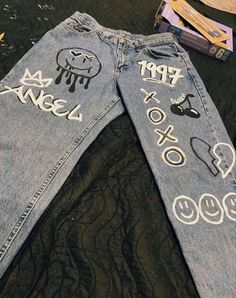 an old pair of jeans that have been decorated with stickers and writing on them