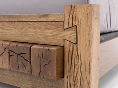 a wooden bed frame with arrows carved into the side and foot boards on each side