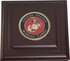 the marine seal plaque is on display in front of a white background and brown frame