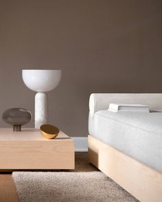 a bedroom with a bed, nightstand and lamp in it's centerpieces