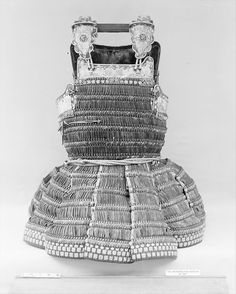 an old photo of a dress made out of silver and glass beads on the bottom