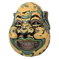 a mask with an open mouth is shown on a white background in this image there are two eyes and one nose that appears to be smiling