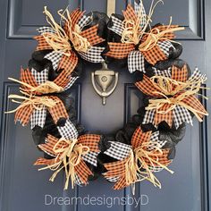 a black and orange wreath on the front door