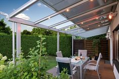 an outdoor dining area with table and chairs