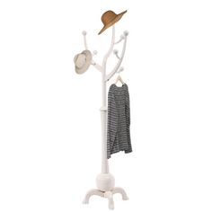 a white coat rack with hats and clothes hanging from it's hooks, on a white background