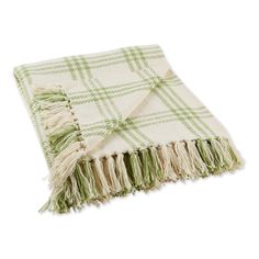 a green and white plaid blanket with fringes