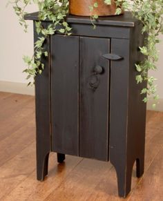 a potted plant sitting on top of a wooden cabinet