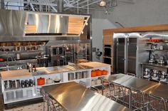 an industrial kitchen with stainless steel appliances and counters