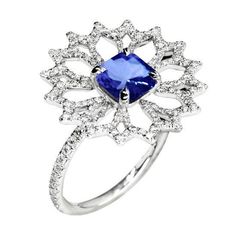 a ring with a blue stone surrounded by white diamonds