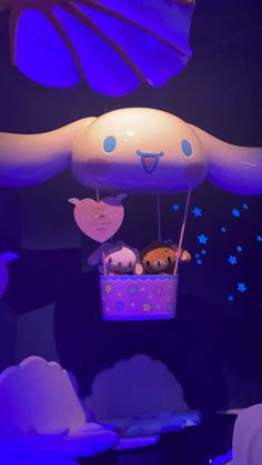 an inflatable balloon with two stuffed animals inside and stars on the ceiling above