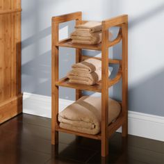 a wooden shelf with towels on top of it