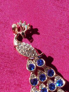 A beautiful peacock motif pendant.  It has blue CZ stones.  Makes a beautiful accessory with any type of outfit. Peacock Motif, Peacock Pendant, Beautiful Peacock, Cz Stone, Blue Stone, Pendant Necklaces, Aurora, Jewelry Necklace Pendant, Jewelry Necklaces