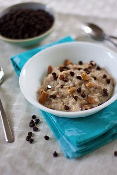 a bowl of oatmeal with nuts and chocolate chips