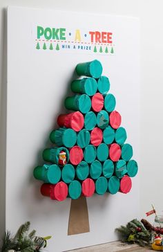 a christmas tree made out of toilet paper rolls on top of a white board with the words poke - a - tree written above it