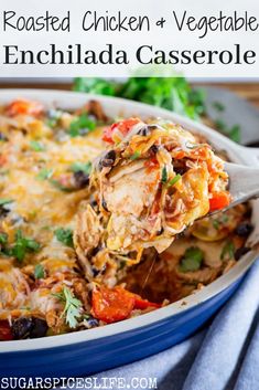 a casserole dish with shredded chicken and vegetables in it is being held by a spoon