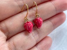 These strawberry dangle earrings are cute and dainty, which are perfect gift for friends and lovers.  They are made of the followings: 🍓Strawberry charm: gold plated over brass with rose red enamel (size: 12 x 8 mm) 🍓Earring hooks and chain: gold plated over brass 【BEFORE PURCHASE, PLEASE NOTE THE FOLLOWINGS】 ☆ VAT, GST and any other taxes from your country are NOT included in the listing price. Buyers are responsible for any aforesaid taxes and must be paid upon delivery. ☆ Buyers are respons Red Hypoallergenic Dainty Earrings, Dainty Red Earrings For Everyday, Cute Handmade Red Earrings, Whimsical Red Drop Earrings, Dainty Handmade Red Earrings, Food Strawberry, Strawberry Jewelry, Miniature Fruit, Strawberry Earrings