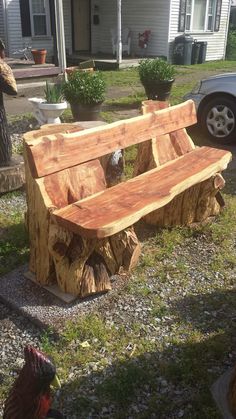 a wooden bench sitting in the middle of a yard