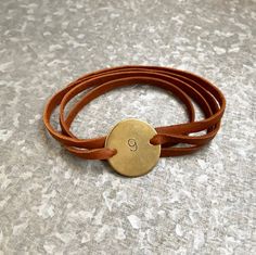 ********Please note jewelry items will ship separately and quicker than the other items in our shop!***********Our bracelets are made of super soft deerskin leather and feature your Enneagram number on a hand stamped 1 inch brass disc. The disc comes strung on 30 inches of supple leather that will fit any size wrist. No clasps to mess with as this easy to wear piece can be wrapped around your wrist as many times as you like, knotted and trimmed to size.Brass is a long lasting metal but will tarn Vintage Brown Wrap Bracelet Gift, Vintage Brown Wrap Bracelet, Nickel Free Brown Wrap Bracelet As Gift, Nickel Free Brown Wrap Bracelet For Gift, Brown Hand Stamped Bracelets For Everyday, Nickel-free Brown Wrap Bracelet As Gift, Nickel-free Brown Wrap Bracelet Gift, Everyday Brown Hand Stamped Bracelet, Vintage Handmade Wrap Bracelet For Gift