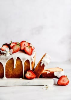 a bundt cake with icing and strawberries on top