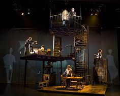 the stage is set for an upcoming play with people standing on it and sitting at tables