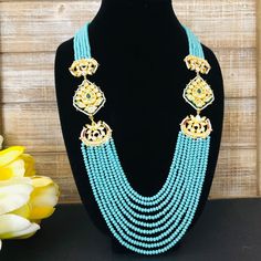 Turquoise Beads Necklace / Blue Beads Long Necklace/ Beaded Kundan Jadau Mala / Statement Necklace/ Blue Multi strand Beaded Mala Description: Made in Brass with Turquoise Blue beads Necklace Length: 11" Necklace comes with Golden Thread Dori Extension at the end for adjustable length Made with very high quality turquoise Blue beads Suitable for any festive/special occasion Comes with Designer Broch Pendants on both sides with Kundan, Meenakari and Pearl work. Blue Beaded Chain Jewelry For Wedding, Traditional Blue Oval Beads Jewelry, Bohemian Blue Pearl Necklace With Gemstone Beads, Traditional Blue Beaded Necklaces, Blue Bohemian Pearl Necklace With Gemstone Beads, Traditional Blue Oval Beaded Jewelry, Traditional Blue Beaded Jewelry, Traditional Blue Beaded Long Necklace, Traditional Blue Long Beaded Necklaces