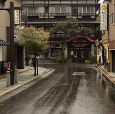 an empty city street with buildings on both sides