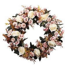 a wreath with white and pink flowers on it