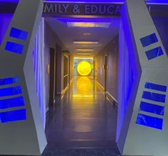 the entrance to an office building with blue light coming from it's windows and doors