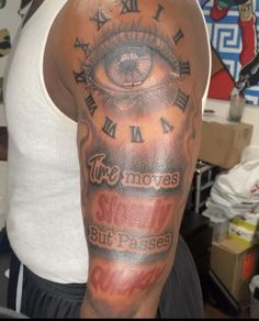 a man with a clock and eye tattoo on his arm