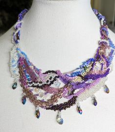 Unique Purple Beaded Necklaces For Crafting, Unique Beaded Crystal Necklaces, Colorful Purple Beaded Necklace, Unique Purple Beaded Necklace With Colorful Beads, Handmade Iridescent Unique Crystal Necklaces, Handmade Bohemian Iridescent Beaded Necklaces, Handmade Bohemian Beaded Necklaces In Iridescent Color, Handmade Bohemian Beaded Iridescent Necklace, Unique Handmade Crystal Beaded Necklaces