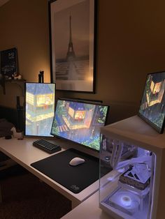 three computer monitors sitting on top of a desk