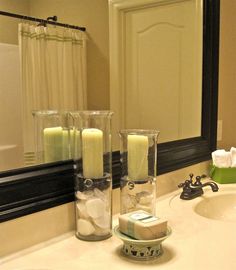 a bathroom sink with candles and soap in it