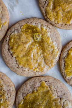 several cookies with yellow toppings sitting on a table