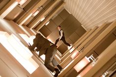 two men are walking through a building together