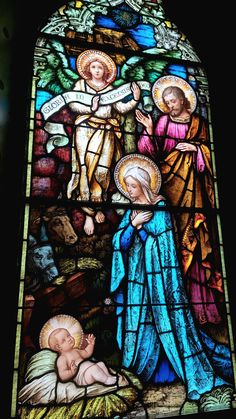 a stained glass window depicting the birth of jesus