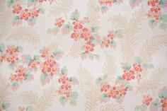 an old wallpaper with pink flowers and green leaves on white background, closeup