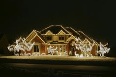 a house covered in christmas lights at night