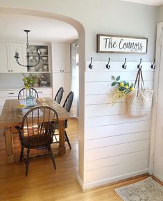 a dining room table and chairs in front of a wall with the words the corners on it