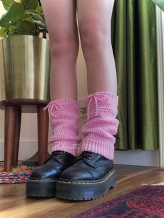 a woman's legs wearing black shoes and pink socks with ruffles on them