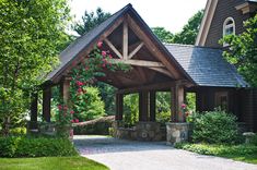 a wooden gazebo sitting in the middle of a lush green park