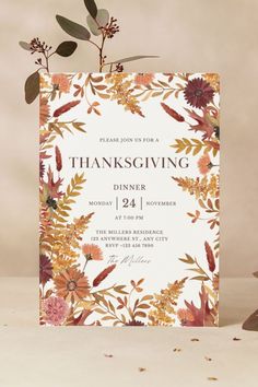 a thanksgiving dinner card with flowers and leaves