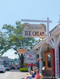 a woman sitting on a bench in front of a ice cream shop