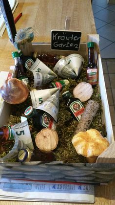 a box filled with assorted condiments on top of a wooden table