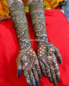 the hands and feet of a woman with henna tattoos on their palms, decorated with flowers