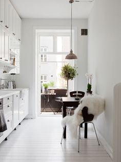 an instagram page with a white kitchen and dining room