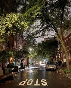 an empty street at night with the word dols painted on the road in white