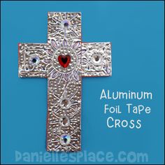 silver duct tape cross with red heart on it and the words silver duct tape cross