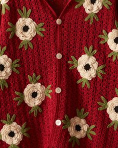 a red sweater with white and black flowers on it